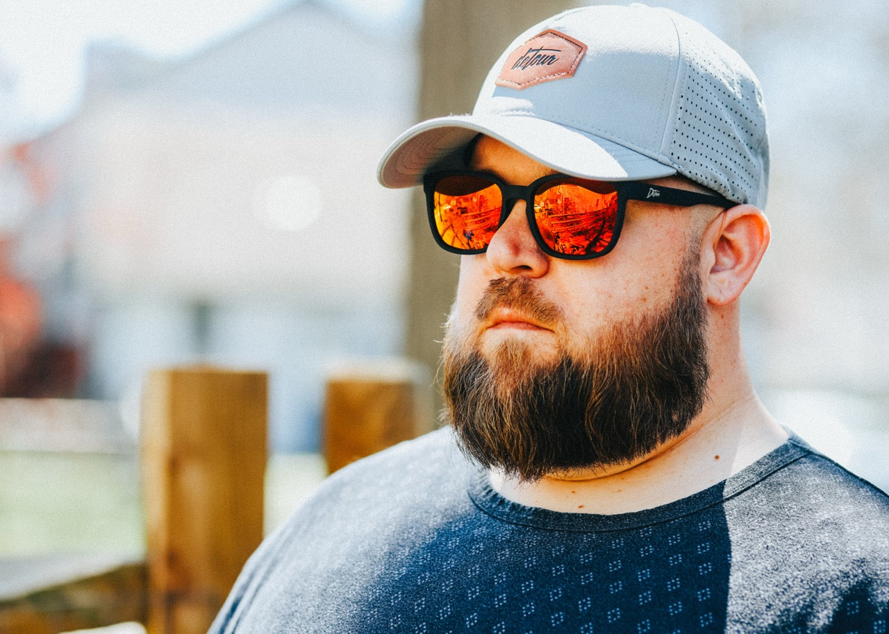 Snowboarder carving through powder in snowy terrain.