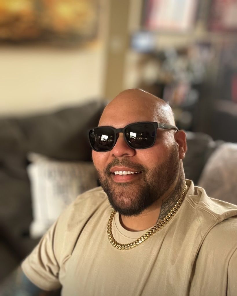 Snowboarder carving through powder in snowy terrain.