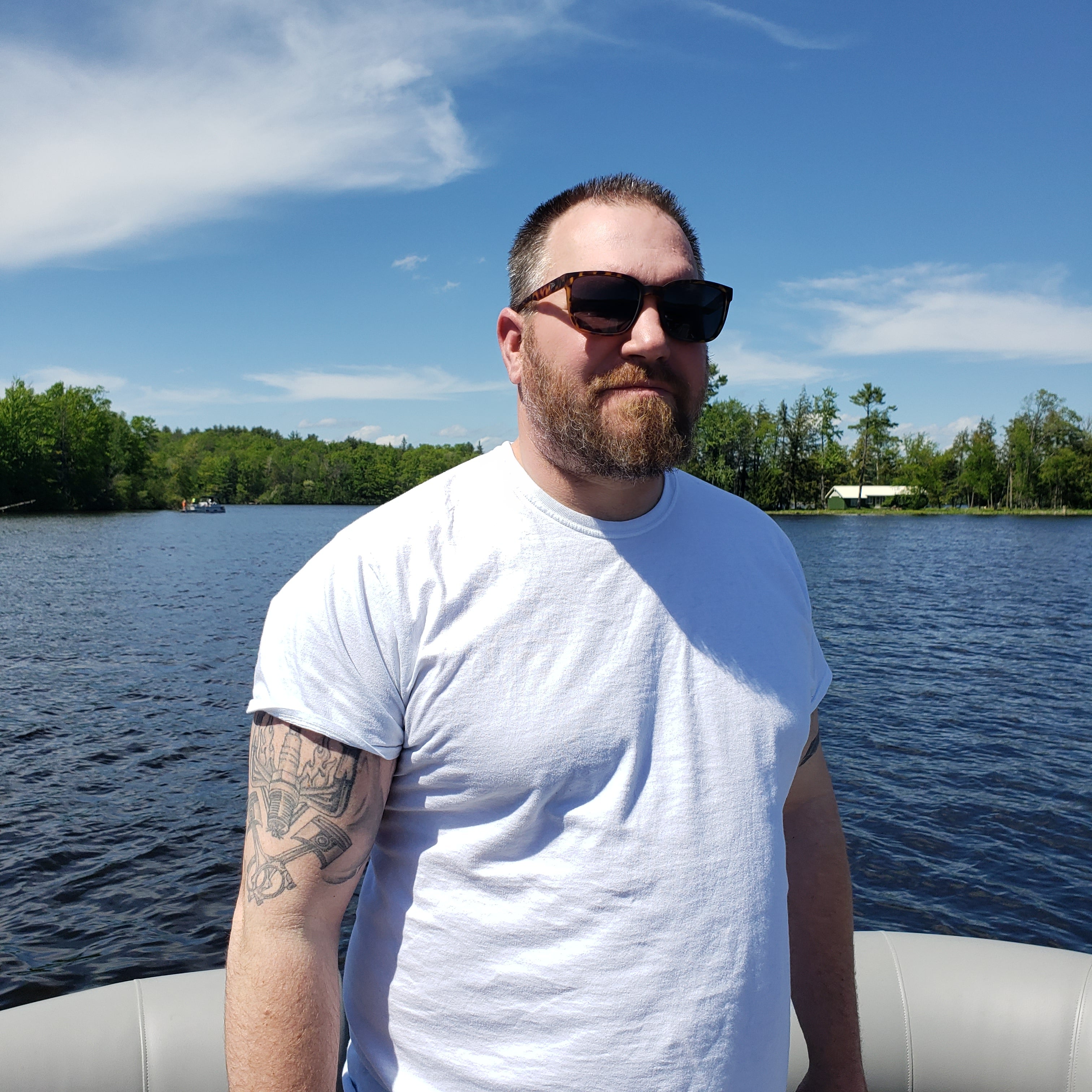 Snowboarder carving through powder in snowy terrain.